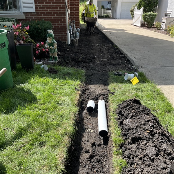 Underground drainage pipes installed in a trench for a Western Springs residential drainage project