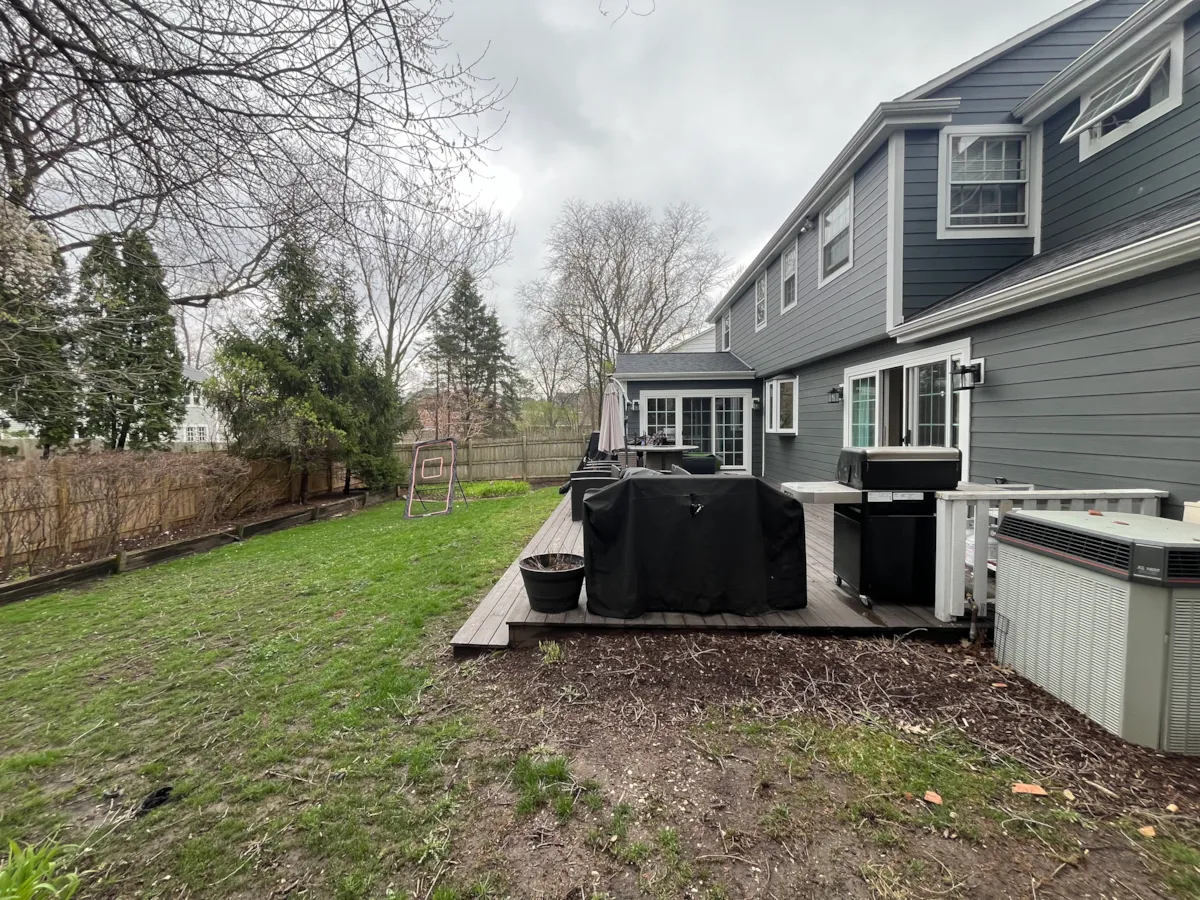 Existing wooden deck and worn backyard before landscape renovation in Hinsdale, IL