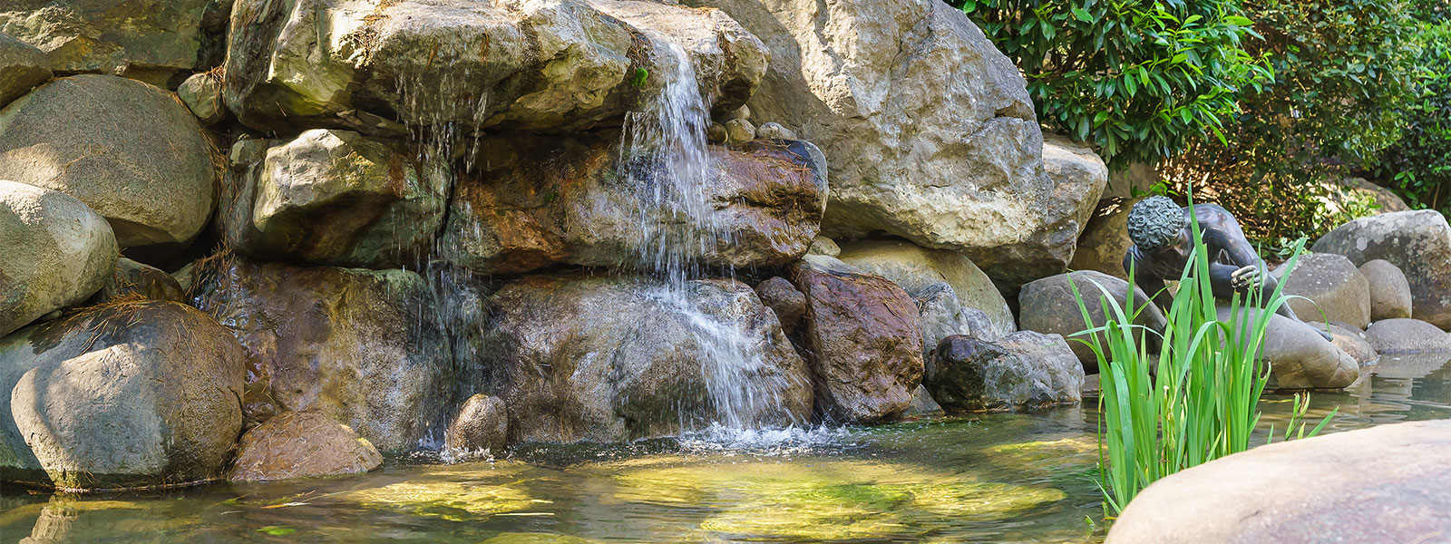 Natural stone waterfall pond installation