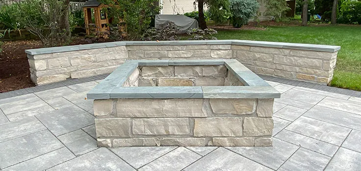 Stone fire pit seating wall installation